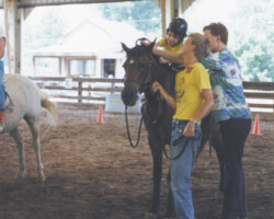 Round Robin's Easter Bonnet helps out at a Therapeutic Horsemanship session in the 1980s. Round Robin's Easter Bonnet helps out at a Therapeutic Horsemanship session in the 1980s.