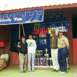 BJ Wilson, Marian "Doc" Molthan, MD, and Dave and Kathy Johnson stand in front of the ribbons and trophies won by Foxglove and Kerrymor farms at the West Coast Connemara Show in August 1986 in Ventura, California. Willoway Farm was the farm name of Dave and Kathy Johnson, who served as trainers for the show. BJ was their catch rider. Doc owned Spring Ledge Irish Whiskey, ridden at the show by Kathy McCarthy, and Kerrymor Spotlight, ridden by Joan McKenna Jr. Terry McKenna rode Kerrymor's Autumn Hope and Kerrymor Lady Diana.