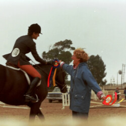 Kerrymor Spotlight and Joan McKenna Jr. receive a blue ribbon from Joan Ervin at the West Coast Connemara Show in 1986 in Ventura, California.