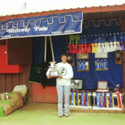 Marian Molthan, MD, of Foxglove Farm, holds one of Spring Ledge Irish Whiskey's championship trophies at the 1986 West Coast Connemara Show in Ventura, California. Whiskers competed in hunters, Western and driving classes. The ribbons behind Doc represent the winnings of Foxglove and Kerrymor farms. Marian Molthan, MD, of Foxglove Farm, holds one of Spring Ledge Irish Whiskey's championship trophies at the 1986 West Coast Connemara Show in Ventura, California. Whiskers competed in hunters, Western and driving classes. The ribbons behind Doc represent the winnings of Foxglove and Kerrymor farms.